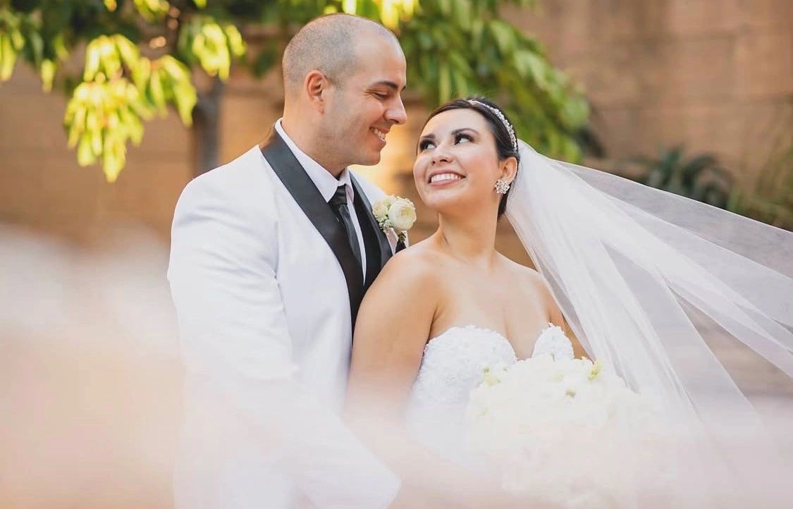 Wedding couple smiling outdoors